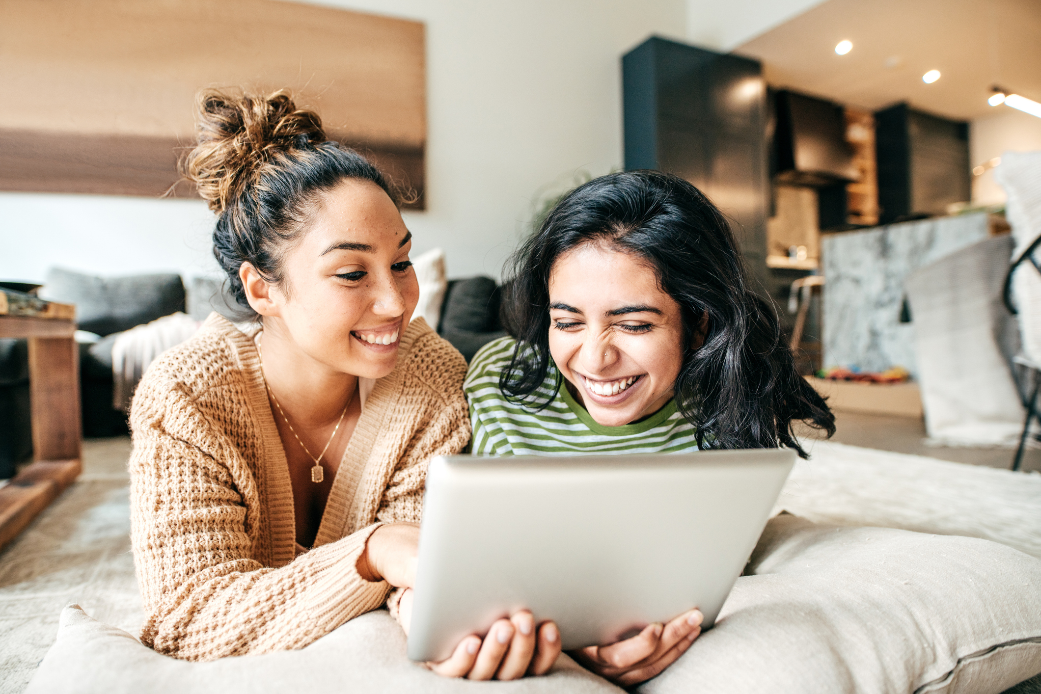 roommates laughing on living room floor
