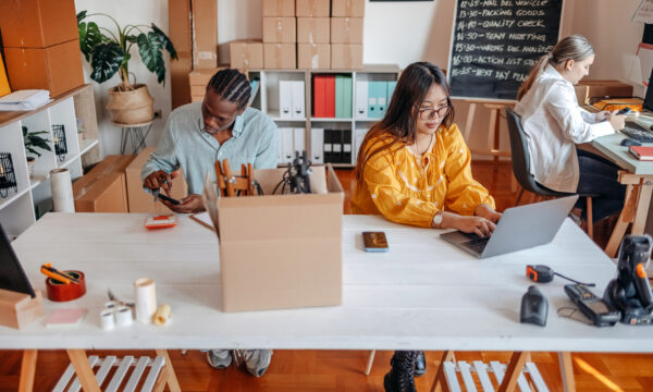 Young people enjoying working at home with packing, selling and delivery service