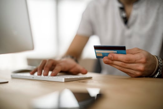 TD Bank credit card holder using the card to make an online purchase on his desktop