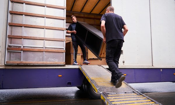 Two people loading a moving truck.
