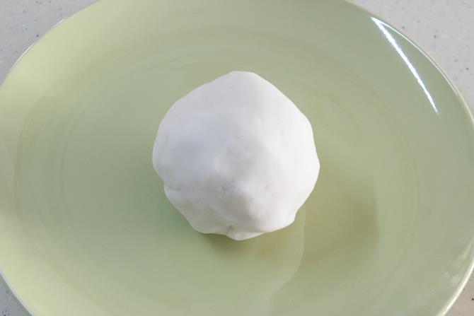 kneading rice flour dough to make kudumulu