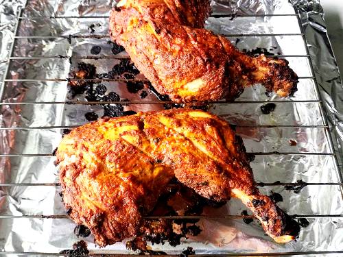 broiled chicken tandoori on a oven rack