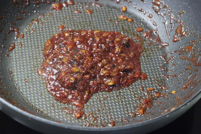 cooking sauce until thickened for schezwan fried rice