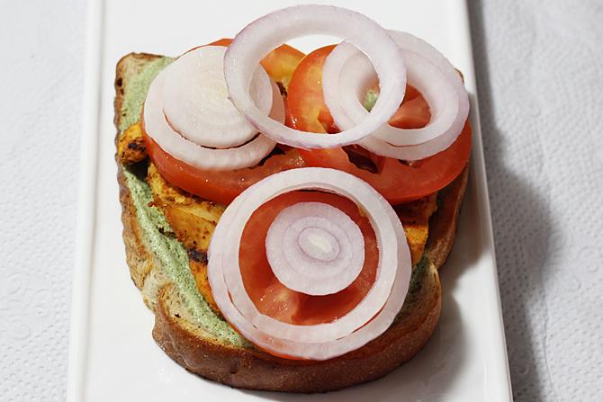 Add veggies to assemble grilled chicken sandwich