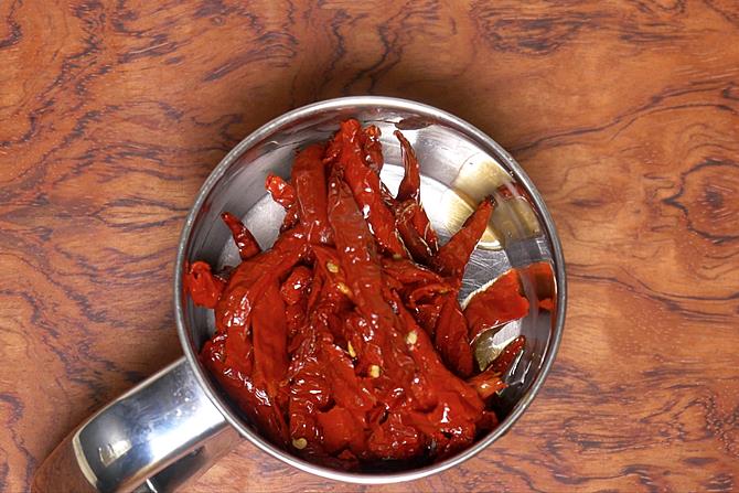 adding chilies to blender to make schezwan sauce