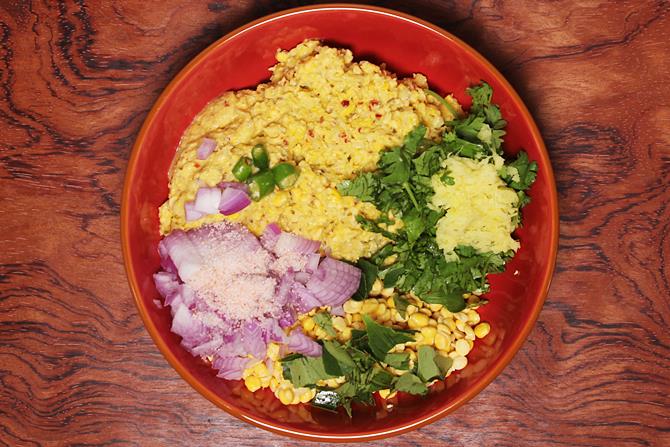 Add salt, onions, chilies, ginger paste to make corn ambode
