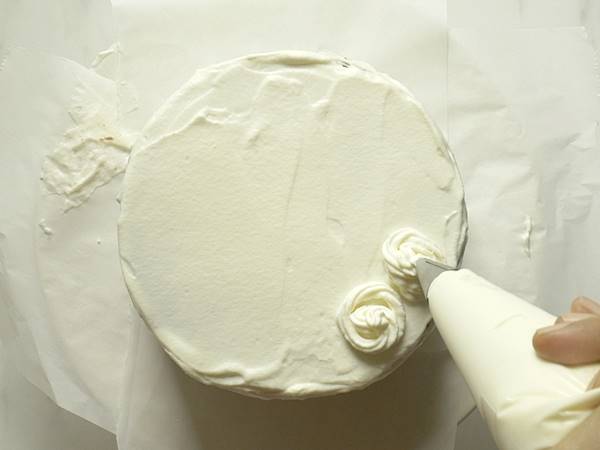 Repeat frosting cream all over the cake