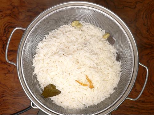 draining basmati rice to colander for hyderabadi biryani recipe