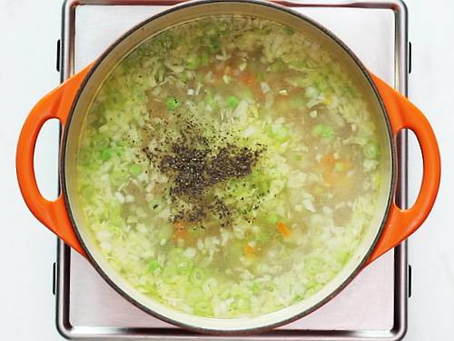 adding pepper in vegetable soup