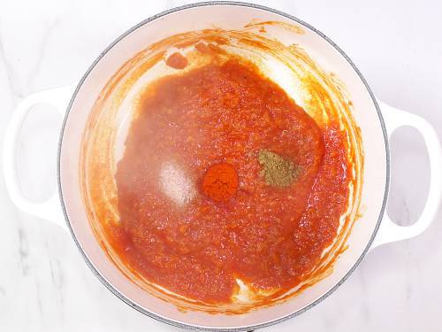 adding spice powders to make makhani masala