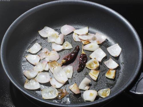 frying red chilies in oil to temper