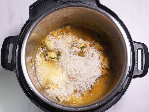 add rice and pour water to make mushroom biryani