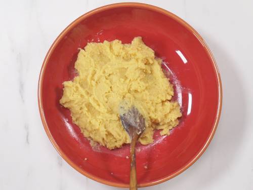 soft khoya in a red bowl, kept for cooling