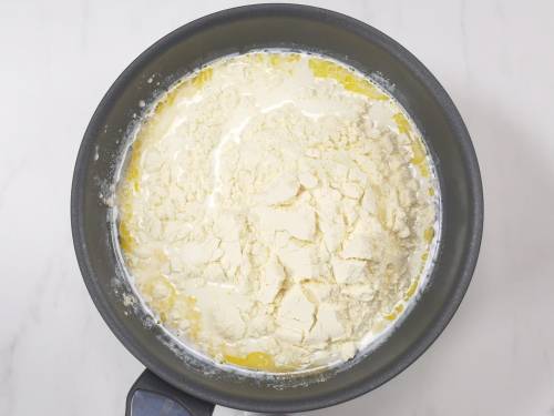 add milk powder to the pan for burfi