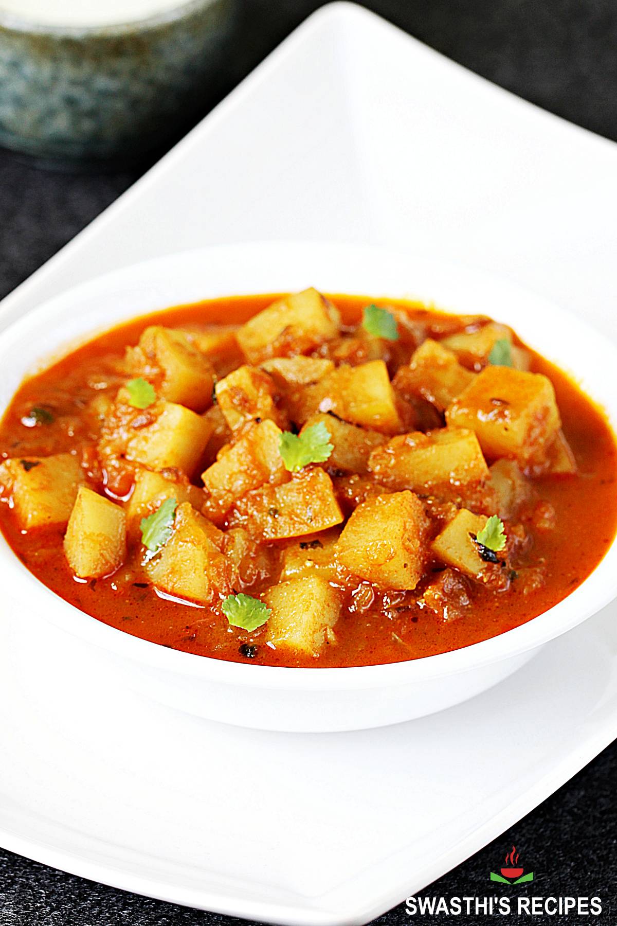 Potato curry served in a white bowl