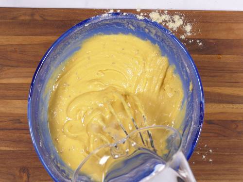 pour water to bring the bajji batter to consistency