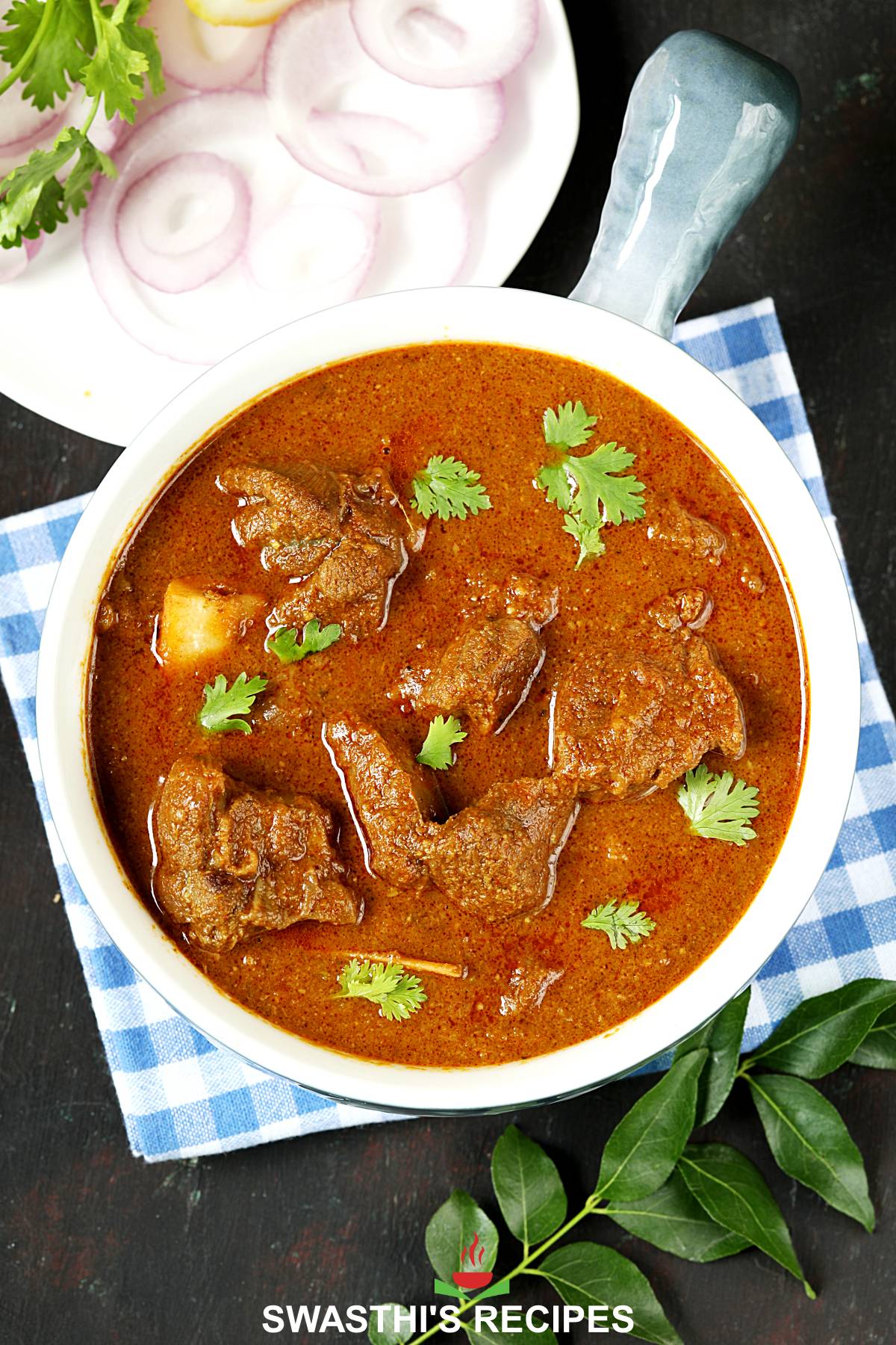 Goat Curry served in a white blue bowl